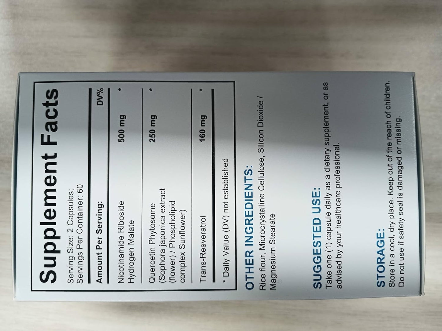 Supplement label with text on a wooden surface